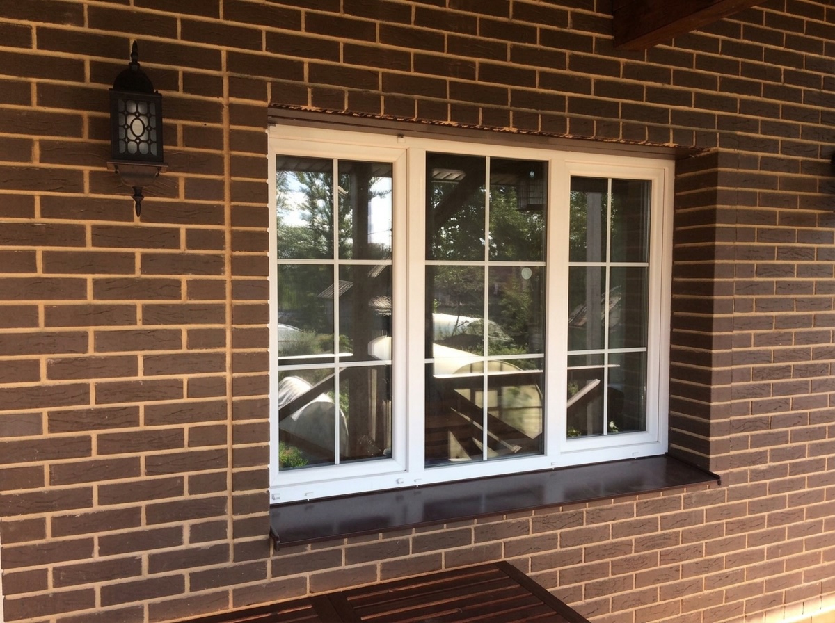 Белое окно ПВХ в кирпичном доме